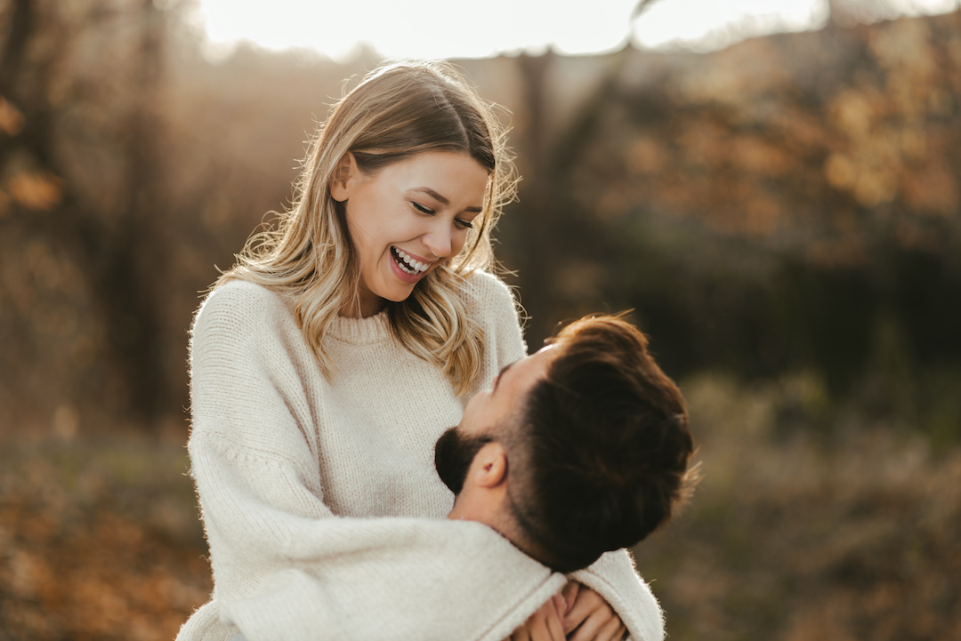 Happy couple having fun in autumn day at the park